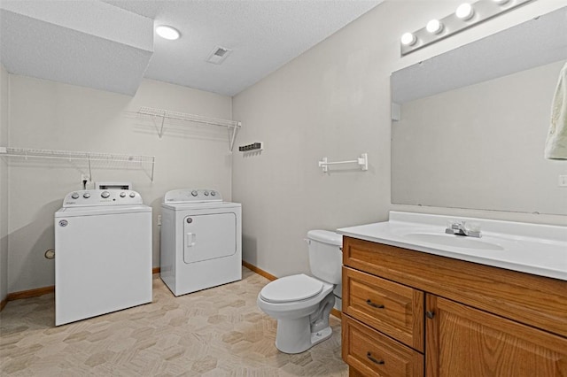 1361 Ozark Rdg, Coralville, IA 52241 - bathroom with independent washer and dryer, vanity, and a textured ceiling