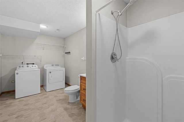 1361 Ozark Rdg, Coralville, IA 52241 - full bathroom featuring washer and dryer, a shower, tile patterned floors, vanity, and a textured ceiling