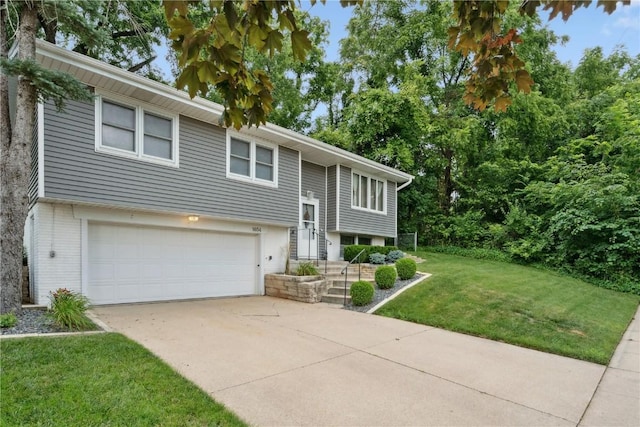 1654 19th St NW, Cedar Rapids, IA 52405 - raised ranch featuring a front lawn, driveway, a garage, and brick siding