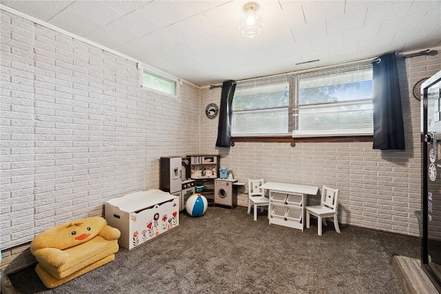 1654 19th St NW, Cedar Rapids, IA 52405 - game room featuring brick wall and carpet flooring