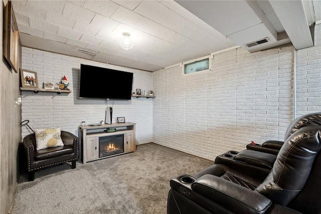 1654 19th St NW, Cedar Rapids, IA 52405 - living area with brick wall, a glass covered fireplace, and carpet flooring