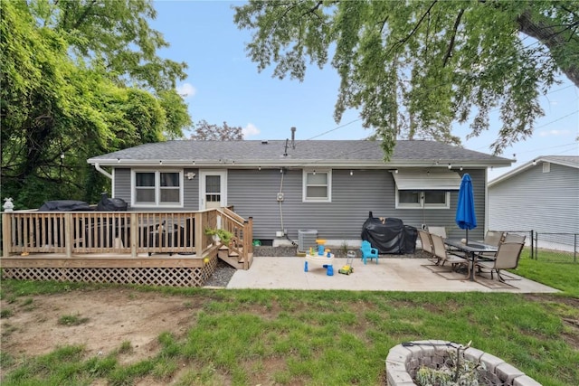 1654 19th St NW, Cedar Rapids, IA 52405 - back of property featuring a wooden deck, a patio, an outdoor fire pit, and roof with shingles
