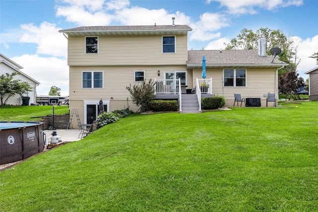 364 Essex Dr NE, Cedar Rapids, IA 52402 - rear view of property featuring a deck, a lawn, a patio, and roof with shingles