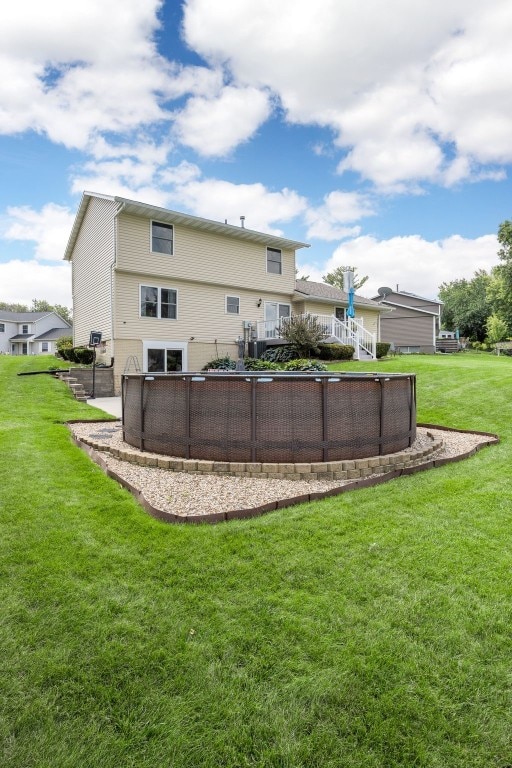364 Essex Dr NE, Cedar Rapids, IA 52402 - back of house with an outdoor pool and a yard