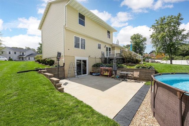 364 Essex Dr NE, Cedar Rapids, IA 52402 - back of property with a yard, a patio area, and brick siding