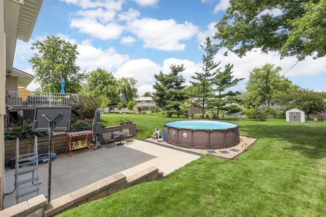 364 Essex Dr NE, Cedar Rapids, IA 52402 - view of green lawn featuring a storage shed, a patio area, and an outdoor pool