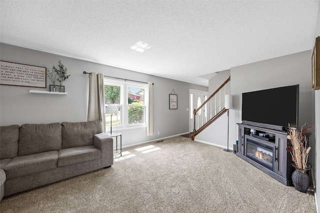 364 Essex Dr NE, Cedar Rapids, IA 52402 - carpeted living area with stairs and a textured ceiling