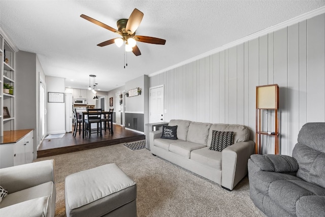364 Essex Dr NE, Cedar Rapids, IA 52402 - living area with ceiling fan, ornamental molding, and dark carpet