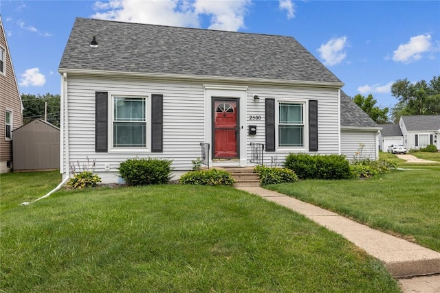 2500 D Ave NE, Cedar Rapids, IA 52402 - cape cod house with a front lawn, roof with shingles, and a storage unit