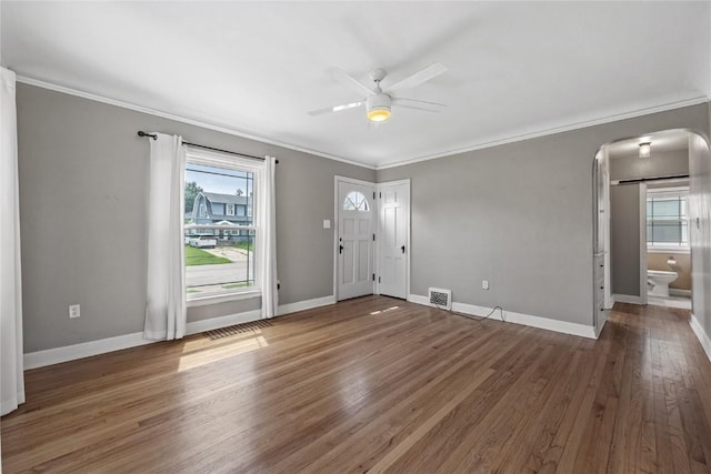 2500 D Ave NE, Cedar Rapids, IA 52402 - foyer featuring arched walkways, ceiling fan, plenty of natural light, crown molding, and wood finished floors
