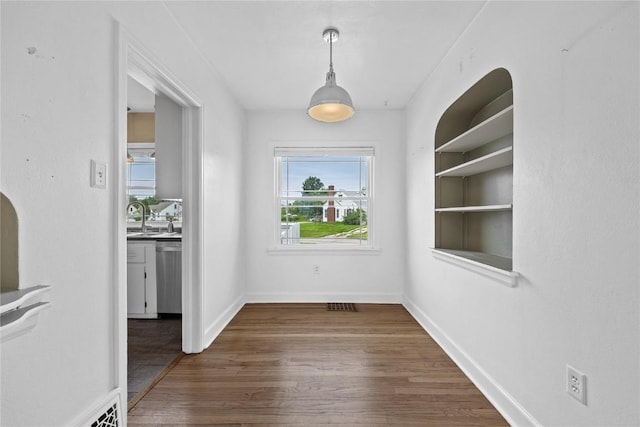 2500 D Ave NE, Cedar Rapids, IA 52402 - unfurnished dining area with wood finished floors and a sink