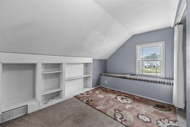 2500 D Ave NE, Cedar Rapids, IA 52402 - additional living space featuring vaulted ceiling, carpet flooring, built in features, and a textured ceiling