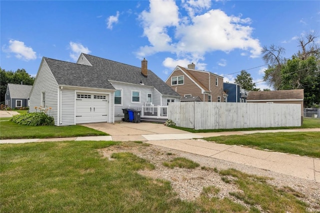 2500 D Ave NE, Cedar Rapids, IA 52402 - back of property with concrete driveway, a chimney, a garage, and a shingled roof