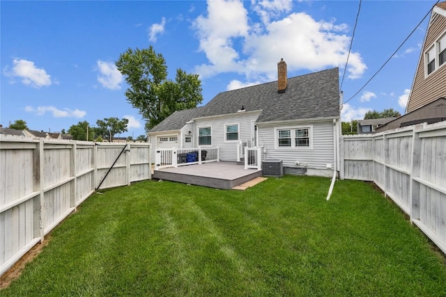 2500 D Ave NE, Cedar Rapids, IA 52402 - rear view of property with a chimney, a fenced backyard, a deck, and a shingled roof