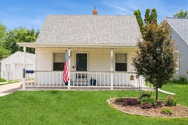 3825 Hart Ct, Cedar Rapids, IA 52402 - view of front facade with a porch, an outbuilding, a shingled roof, and a front yard