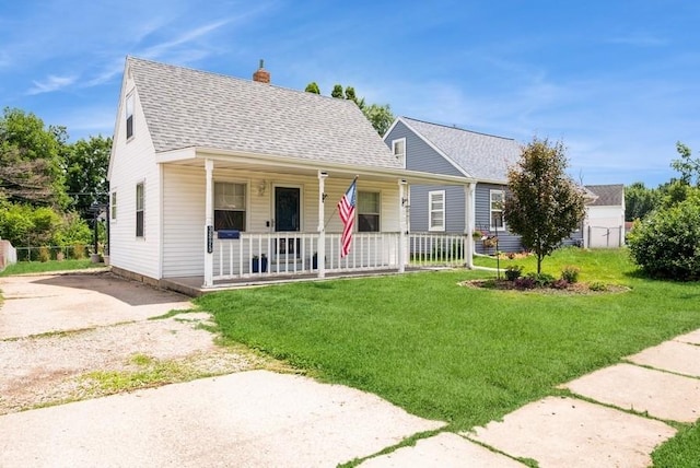 3825 Hart Ct, Cedar Rapids, IA 52402 - view of front of house featuring covered porch, a chimney, a front yard, roof with shingles, and driveway