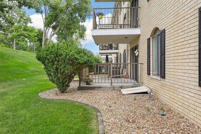 2131 1st Ave Unit 108, Cedar Rapids, IA 52402 - view of grassy yard featuring a balcony and a patio