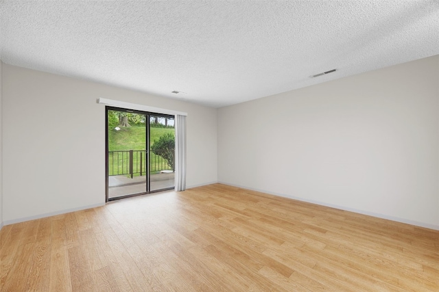2131 1st Ave Unit 108, Cedar Rapids, IA 52402 - spare room with light wood-style flooring and a textured ceiling