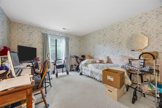 2131 1st Ave Unit 108, Cedar Rapids, IA 52402 - bedroom featuring wallpapered walls, carpet flooring, and a desk