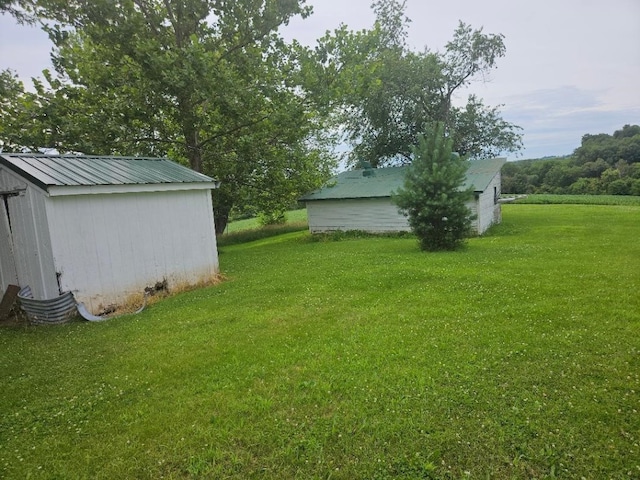 2142 310th Ave, Chelsea, IA 52215 - view of green lawn with a storage shed