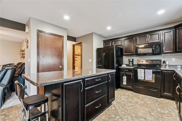 2908 Riviera St SW Unit B, Cedar Rapids, IA 52404 - kitchen featuring black appliances, a kitchen island, light stone countertops, open floor plan, and recessed lighting