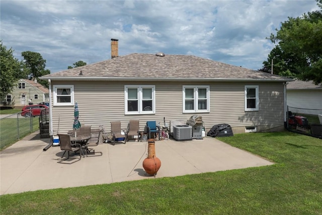 1305 E Ave, Vinton, IA 52349 - rear view of house featuring a chimney, a patio area, and roof with shingles