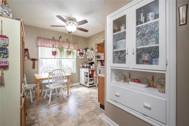 1305 E Ave, Vinton, IA 52349 - dining room with ceiling fan and baseboards