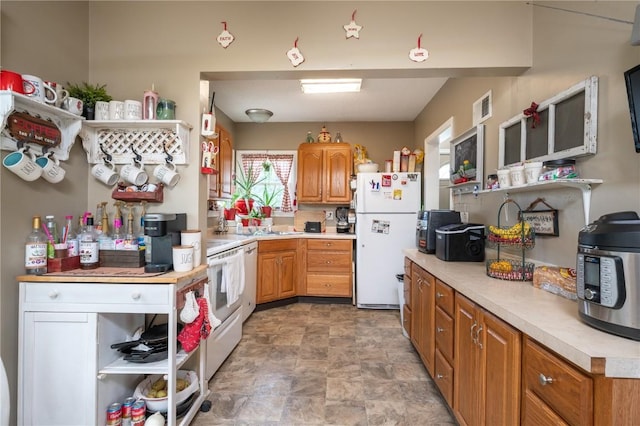 1305 E Ave, Vinton, IA 52349 - kitchen featuring freestanding refrigerator, stone finish flooring, light countertops, and open shelves