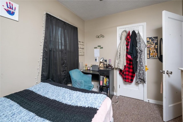 1305 E Ave, Vinton, IA 52349 - carpeted bedroom featuring baseboards and a textured ceiling