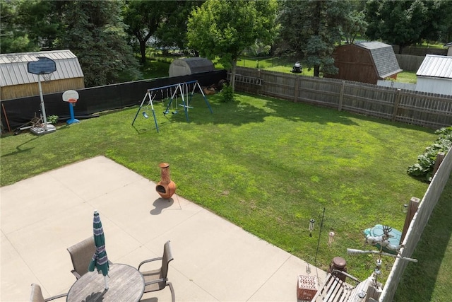 1305 E Ave, Vinton, IA 52349 - fenced backyard featuring a playground, a storage shed, and a patio area