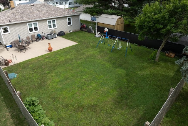 1305 E Ave, Vinton, IA 52349 - fenced backyard featuring a playground and a patio area