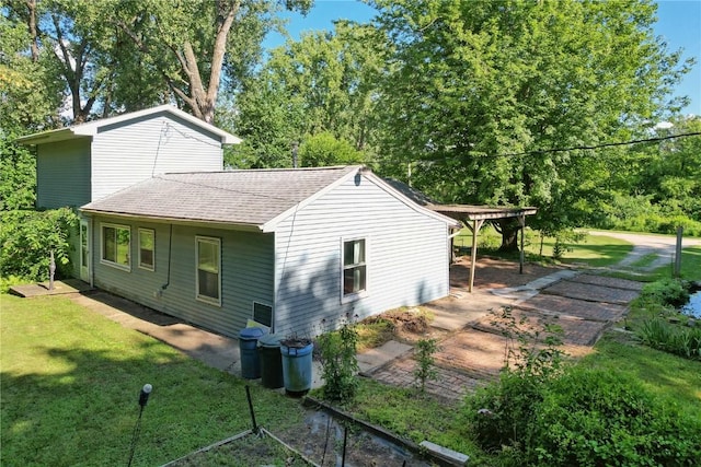 10205 Feather Ridge Rd, Toddville, IA 52341 - view of property exterior with roof with shingles and a yard