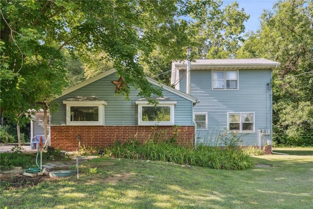 10205 Feather Ridge Rd, Toddville, IA 52341 - rear view of house with a lawn and brick siding