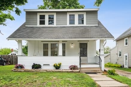 3107 E Ave NE, Cedar Rapids, IA 52402 - bungalow-style home with a porch, a front lawn, and roof with shingles