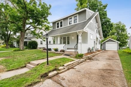 3107 E Ave NE, Cedar Rapids, IA 52402 - bungalow with a detached garage, an outbuilding, driveway, and a front yard