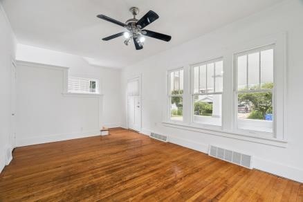 3107 E Ave NE, Cedar Rapids, IA 52402 - unfurnished room featuring wood finished floors and a ceiling fan