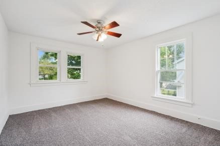 3107 E Ave NE, Cedar Rapids, IA 52402 - carpeted spare room with healthy amount of natural light and ceiling fan