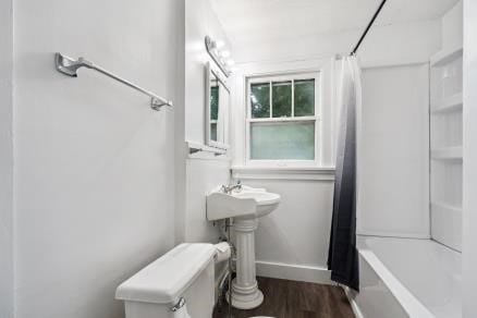 3107 E Ave NE, Cedar Rapids, IA 52402 - full bath featuring wood finished floors and shower / bath combination with curtain
