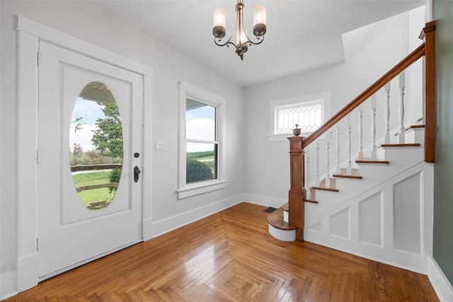 899 Jackson Ave, Mechanicsville, IA 52306 - foyer featuring a chandelier and stairway