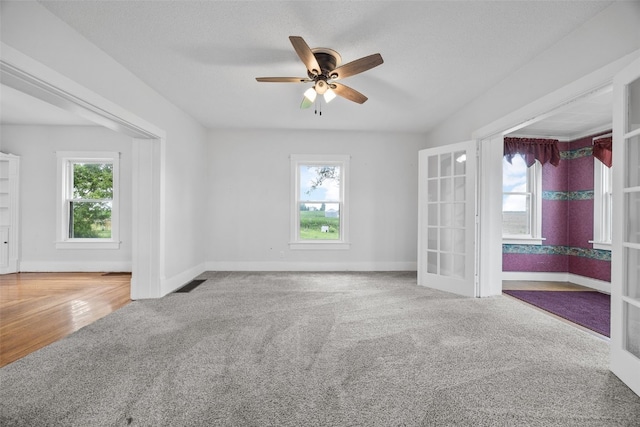 899 Jackson Ave, Mechanicsville, IA 52306 - unfurnished room with french doors, healthy amount of natural light, and carpet flooring