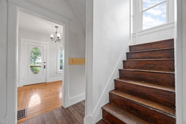 899 Jackson Ave, Mechanicsville, IA 52306 - foyer entrance with a chandelier, stairs, and wood finished floors