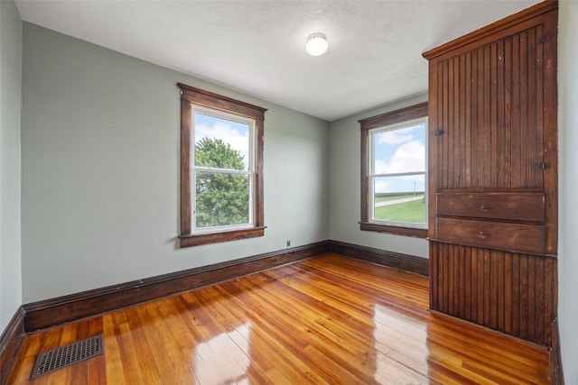 899 Jackson Ave, Mechanicsville, IA 52306 - unfurnished bedroom featuring hardwood / wood-style flooring and baseboards