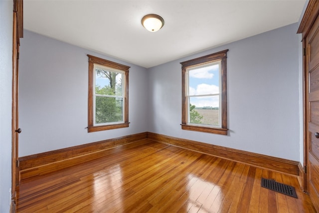 899 Jackson Ave, Mechanicsville, IA 52306 - spare room with hardwood / wood-style flooring and baseboards
