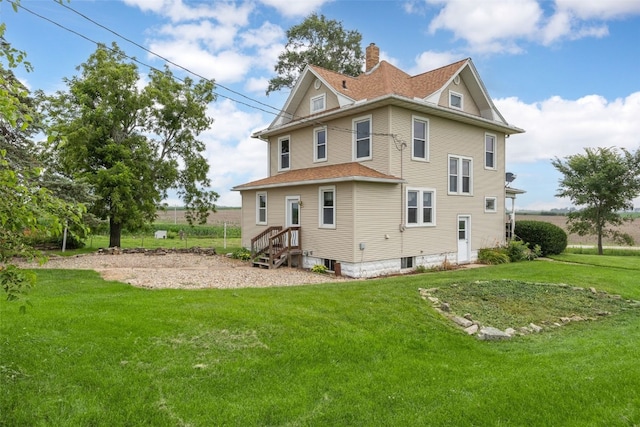 899 Jackson Ave, Mechanicsville, IA 52306 - back of property featuring a yard, a chimney, and roof with shingles