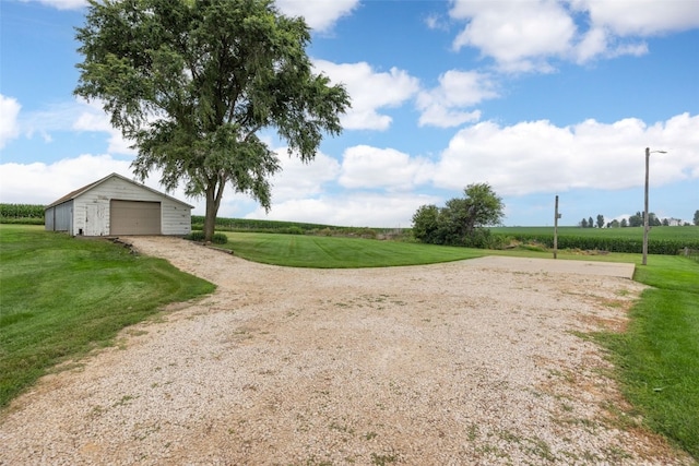 899 Jackson Ave, Mechanicsville, IA 52306 - view of grassy yard with an outbuilding, a detached garage, a rural view, and driveway