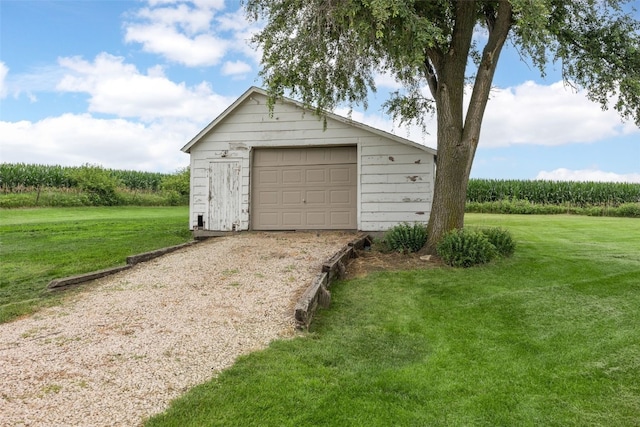 899 Jackson Ave, Mechanicsville, IA 52306 - detached garage with driveway, a rural view, and agricultural plots