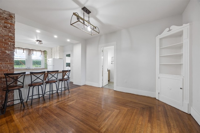 899 Jackson Ave, Mechanicsville, IA 52306 - kitchen with freestanding refrigerator, a breakfast bar, pendant lighting, a peninsula, and recessed lighting