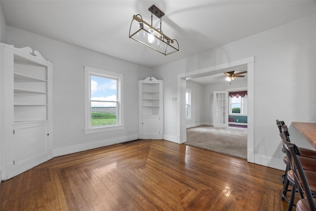 899 Jackson Ave, Mechanicsville, IA 52306 - unfurnished dining area with ceiling fan and baseboards