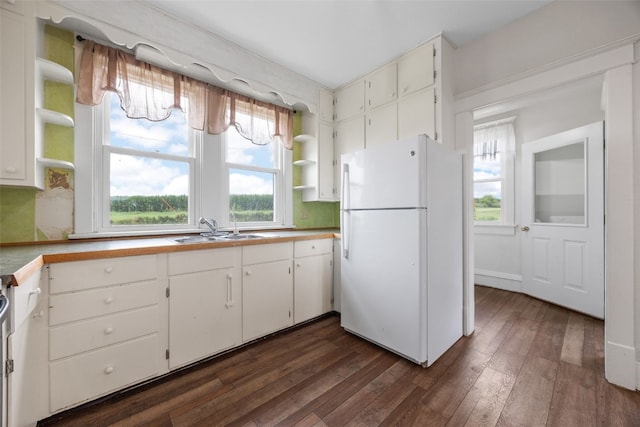 899 Jackson Ave, Mechanicsville, IA 52306 - kitchen featuring freestanding refrigerator, open shelves, dark wood-type flooring, and healthy amount of natural light