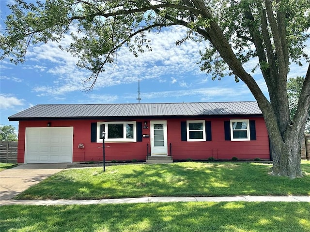 1125 W 10th Ave, Marion, IA 52302 - ranch-style house with entry steps, concrete driveway, a front yard, an attached garage, and a metal roof